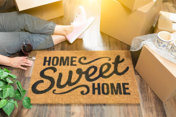 https://media.istockphoto.com/id/962706640/photo/woman-wearing-sweats-relaxing-near-home-sweet-home-welcome-mat-moving-boxes-and-plant.jpg?s=612x612&w=0&k=20&c=z6QD0jx1QAQgXCrR78T-wHzued-Hly37GCHKJxvZEL4=