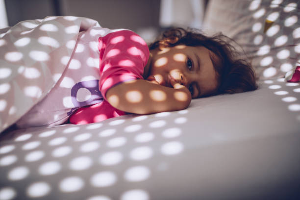 istock Cute little girl lying in bed 962708898