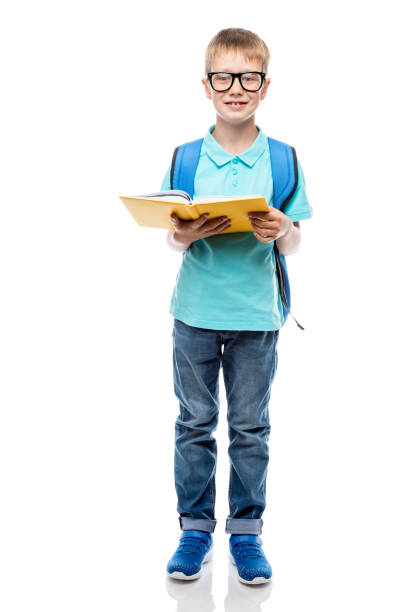 istock smiling schoolboy with backpack and book posing against white background in studio 962717496