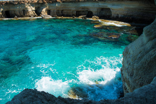 Sea caves near Ayia Napa, Mediterranean sea coast, Cyprus Sea caves (littoral caves) near Ayia Napa, Mediterranean sea coast, Cyprus. They are formed primarily by the wave action of the sea greco stock pictures, royalty-free photos & images