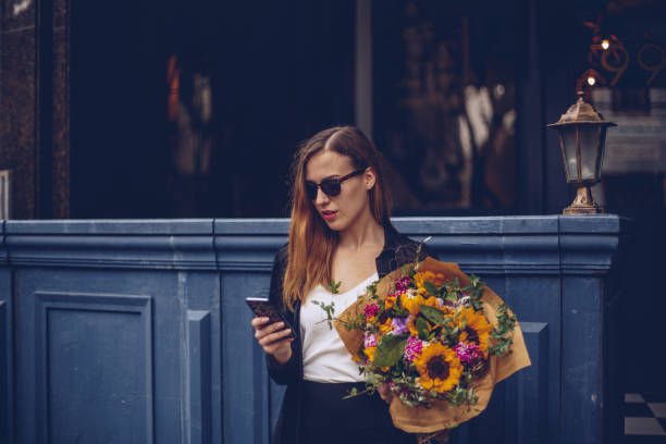 istock Woman holding flower bouquet 962719876