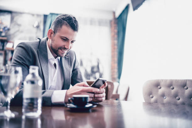 istock Modern Braided Businessman Looking At Funny Video In Restaurant 962720200