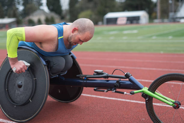 istock Adaptive athlete training on his racing wheelchair at a stadium track 962721894
