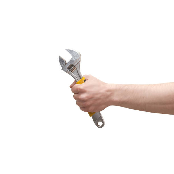 istock Hand holding adjustable wrench isolated on white background 962727042