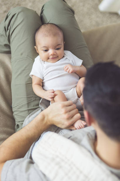 istock New dad holds his infant daughter 962730596