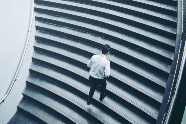 istock Successful businessman running fast upstairs Success concept 962735084
