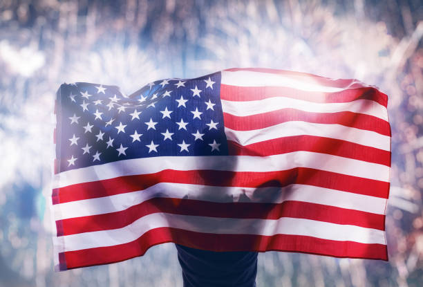 istock Patriotic holiday. Young man looking at fireworks. 962747292