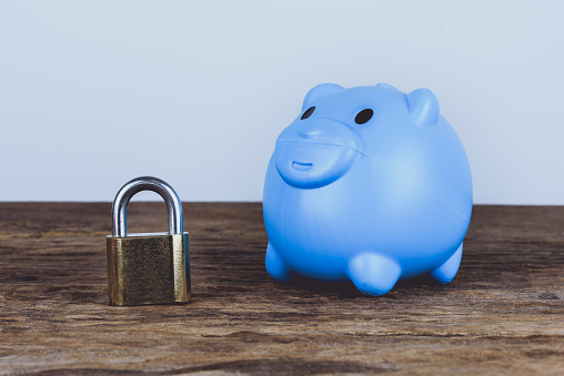 A blue piggybank and lock. Save Money Concept and used for financial protection inferences or other investment messages
