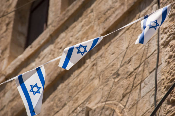 istock Israeli flag blowing in the wind 962753866