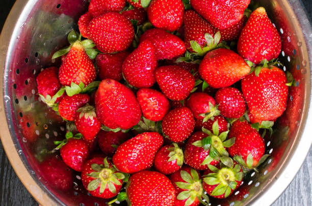 istock raw fresh strawberry in metal colander 962754874