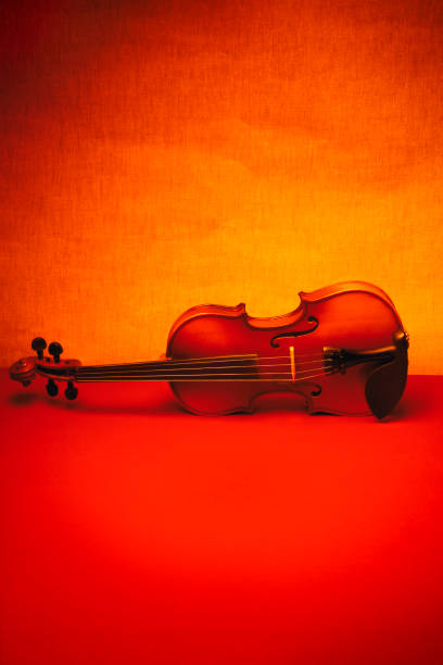 istock Still life with a violin on a red table. 962756188