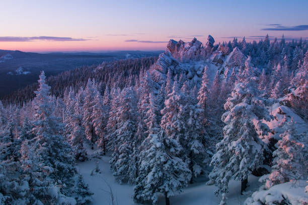 istock Snow-covered forest in the mountains at dawn. 962759926