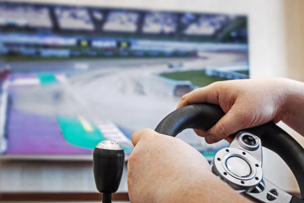 istock hands holding the steering wheel of the game console 962772046