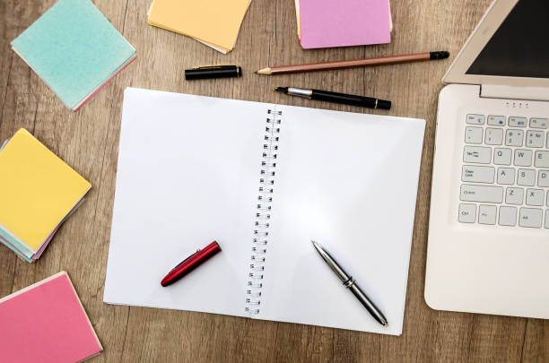 istock notebook, laptop and stickers on a wooden table 962775208