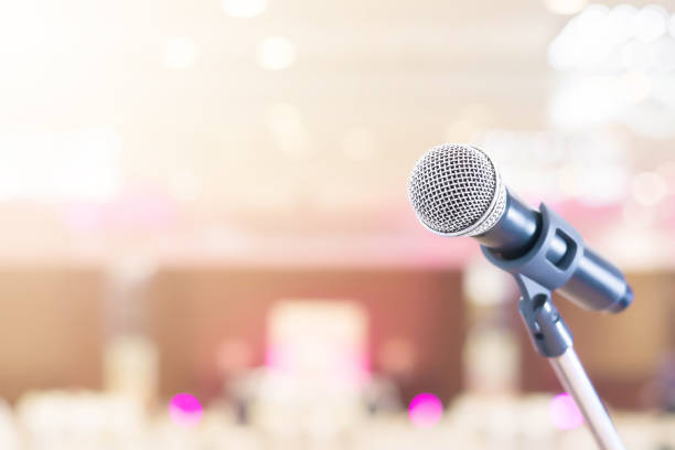 istock Microphone in conference on seminar room event background 962776078