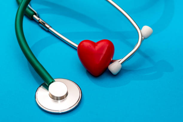 istock The stethoscope and heart are isolated on a blue background 962776554