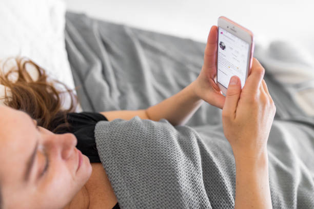 istock Woman With Cellphone in Bed 962776930