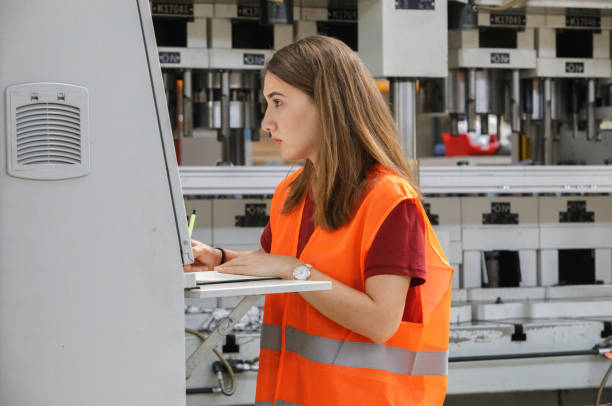 istock Female Trainee Engineer Working in Factory 962777572