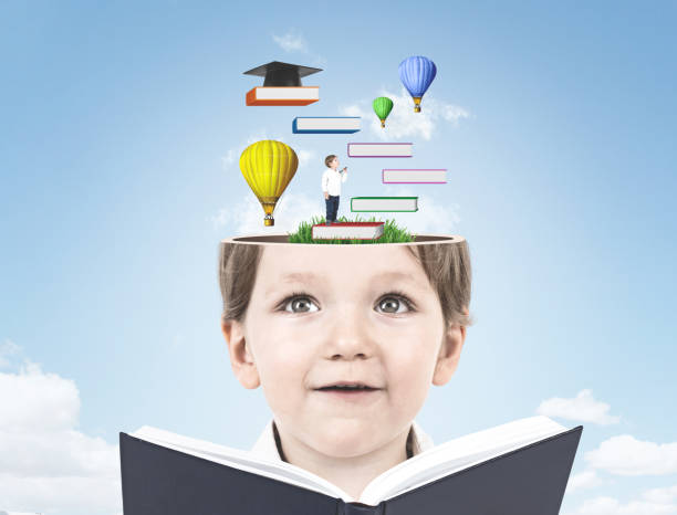 istock Cute little boy with a book, education, sky 962781640