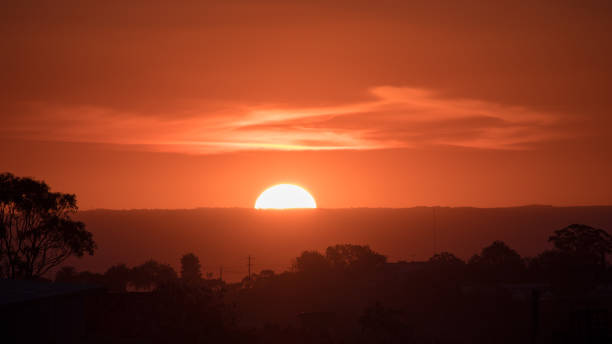 istock Closeup of the sun setting behind some mountains 962781888