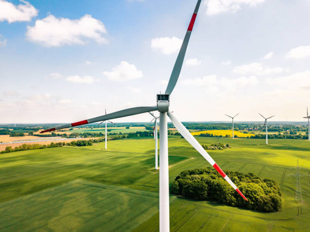 istock wind turbines in sunny landscape 962787724