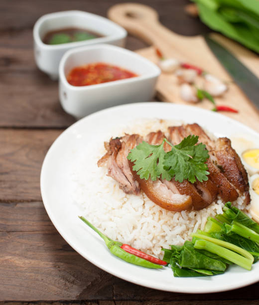 istock Thai stewed pork leg with rice on wood(Kao Kha Moo) 962790772