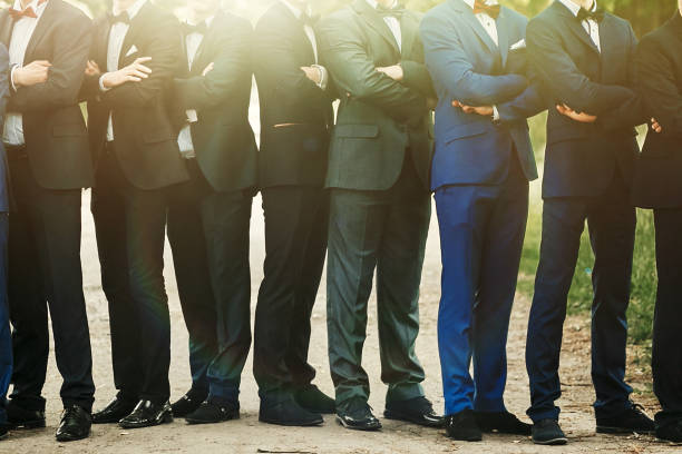 stylish confident men in suit standing posing, reception at luxury wedding, rich graduation at school or university, business meeting