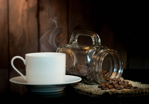 istock coffee cup and coffee beans on old wooden background. 962800750