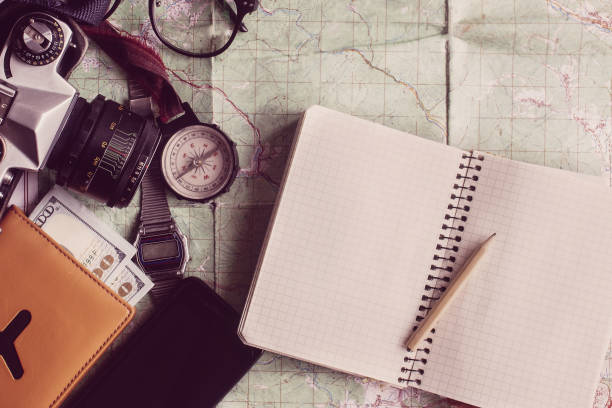 istock wanderlust and adventure concept, compass camera glasses passport money notebook lying on map, top view, space for text, vintage toned image 962803812