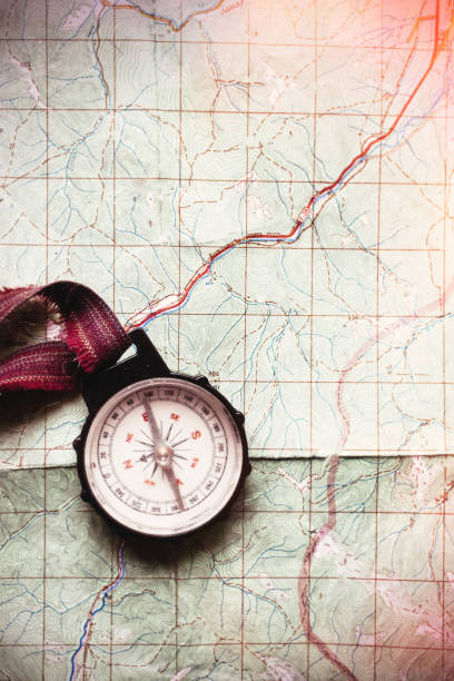 istock wanderlust and explore concept, old compass lying on map, top view, space for text, vintage toned image 962804078