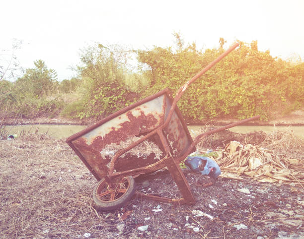 istock Rusty blue wheelbarrow in the forest,vintage color toned image 962805954