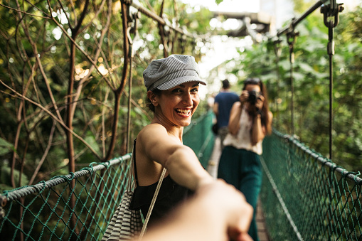 Couple holding hands at the Forest Eco Park in Kuala Lumpur, Malaysia,pov