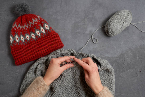 istock Close-up of hands knitting. 962810360