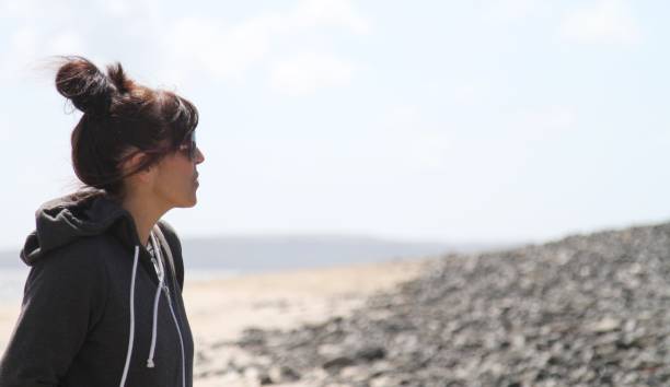 istock side-view of woman at beach 962816834