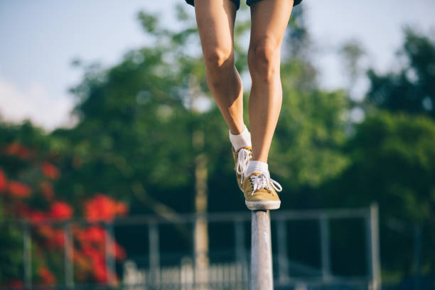 istock Legs walking on steel pipe with balance 962823212