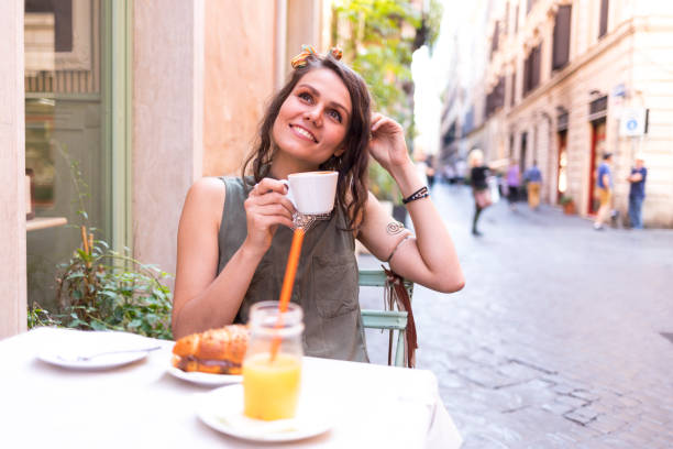 istock Tourist sitting in cafe and drinking coffee 962824202