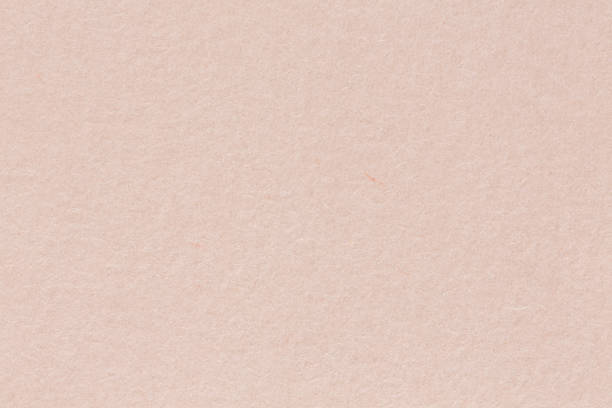 istock A warm-toned, off-white paper background with a finely textured 962826568