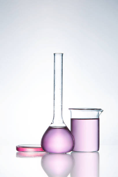 Laboratory Glass. Laboratory Transparent Glassware With Colorful Fluid On Table On White Background. High Resolution.