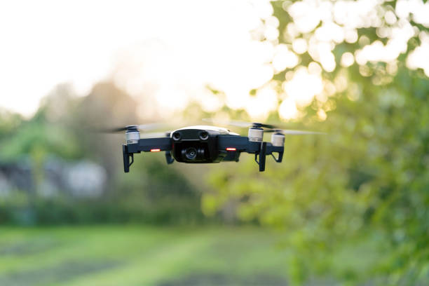 flying quadrocopter, remote controlled drone with camera - quadricóptero imagens e fotografias de stock