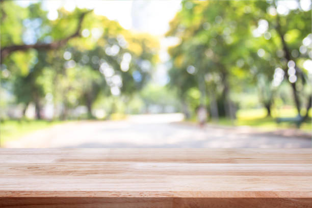 istock empty wooden on blurred nature backdrop. Wood table top. can used for display or montage your products 962833598