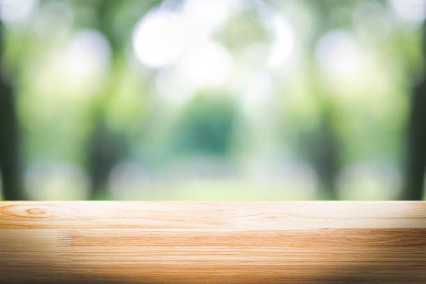 istock empty wooden on blurred nature backdrop. Wood table top. can used for display or montage your products 962833876