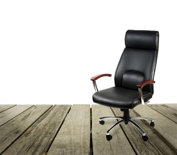 istock Black leather office chair on wood floor over white background 962833884