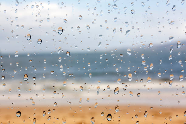Beach through the window in a rainy day. stock photo