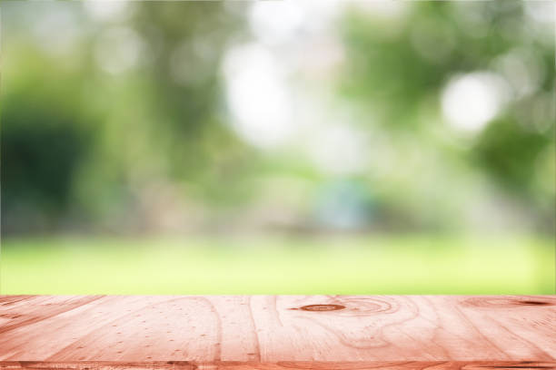 istock empty wooden on blurred nature backdrop. Wood table top. can used for display or montage your products 962837384
