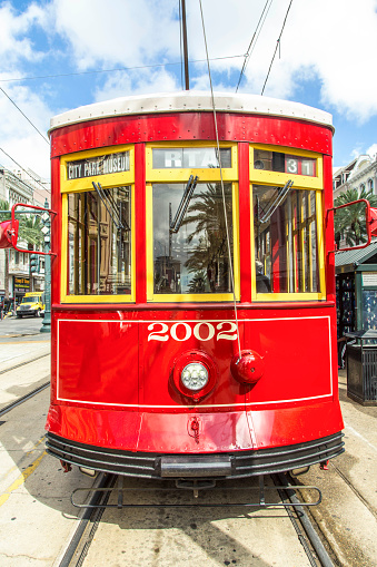 red trolley streetcar on rail in New Orleans in the French Quarter
