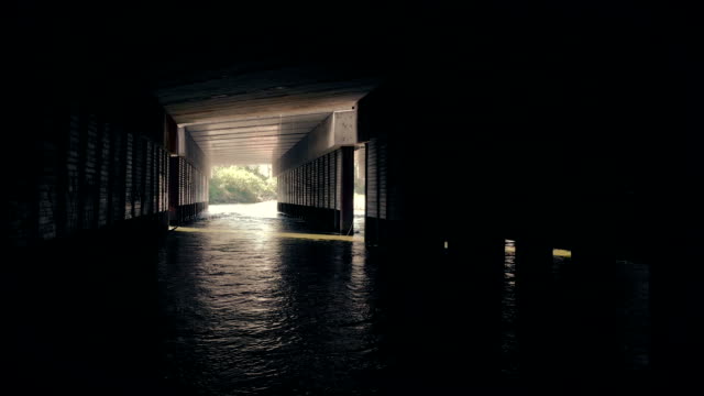 Moving Under Bridge With Water Flowing