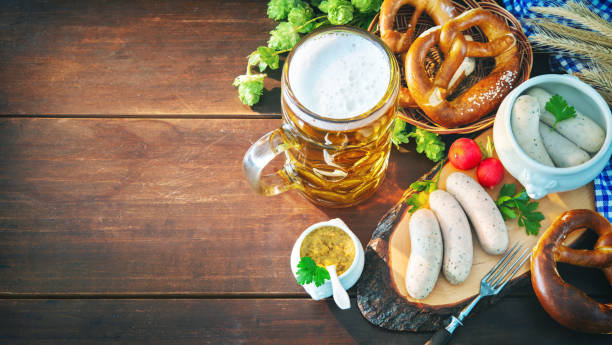 Bavarian sausages with pretzels, sweet mustard and beer mug on rustic wooden table Bavarian sausages with pretzels, sweet mustard and beer mug on rustic wooden table. Beer Fest menu oktoberfest food stock pictures, royalty-free photos & images