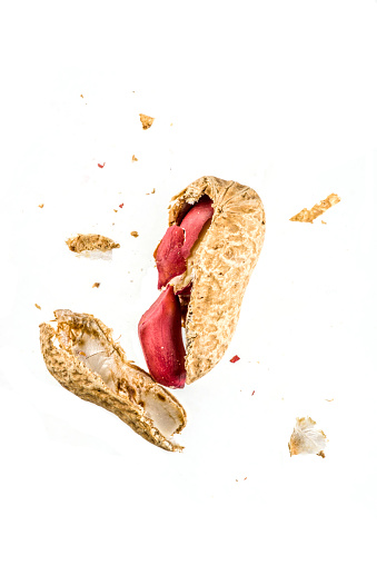 Whole and open peanut nuts isolated on a white background