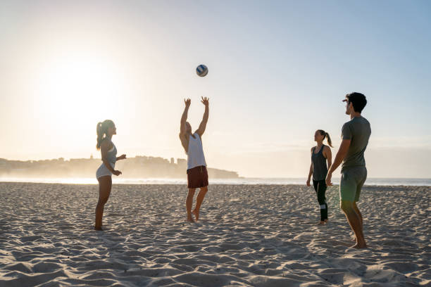 istock Group of people playing volleyball at the beach 962866834