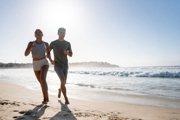 istock Happy couple running at the beach 962866938